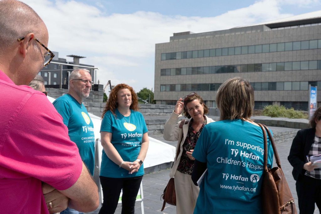 Andy Goldsmith and team talk to Minister for Health and Social Services Elund Morgan outside the Senedd on 18 June 2024