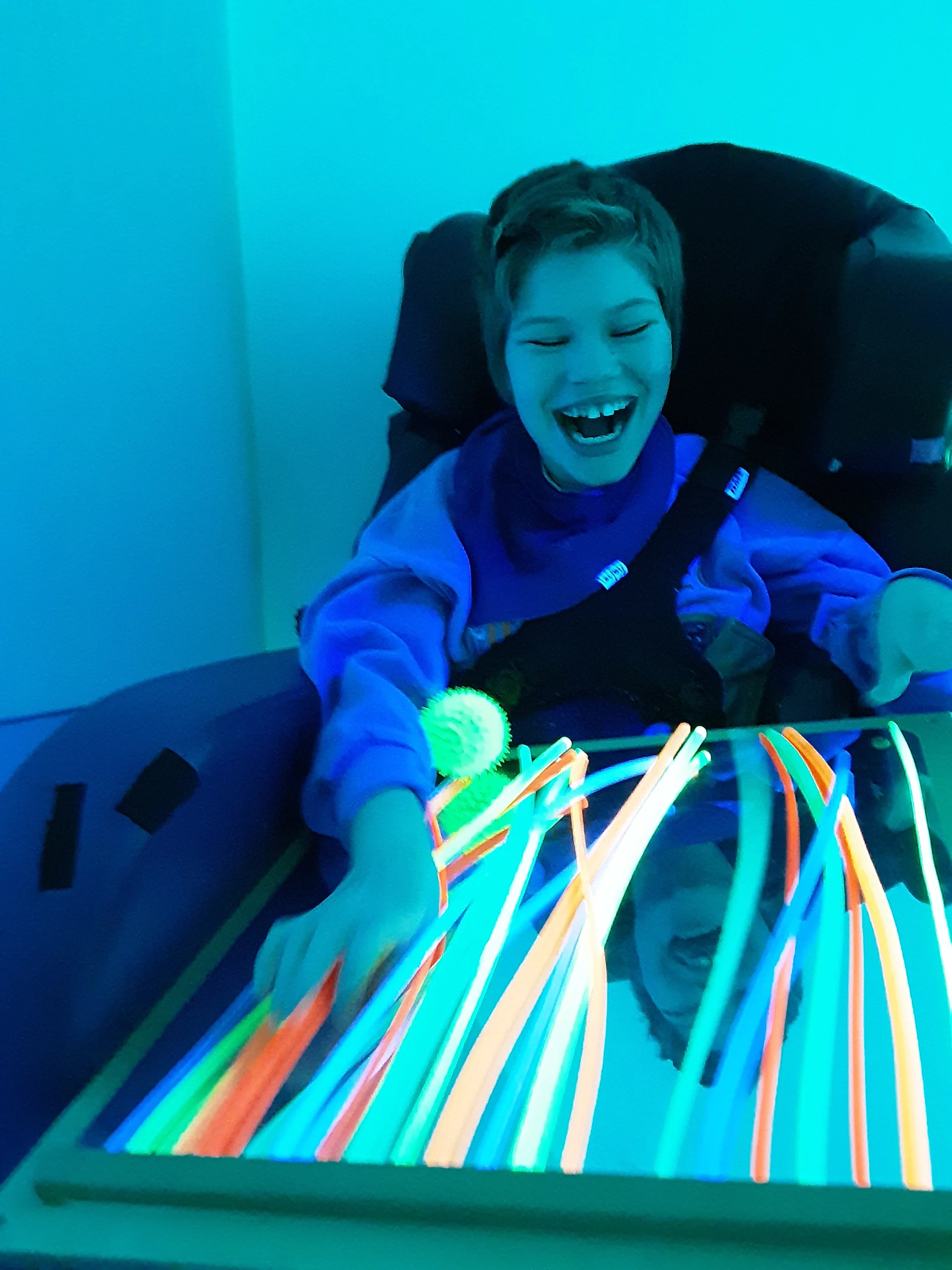 Maisy enjoys the sensory room at Ty Hafan