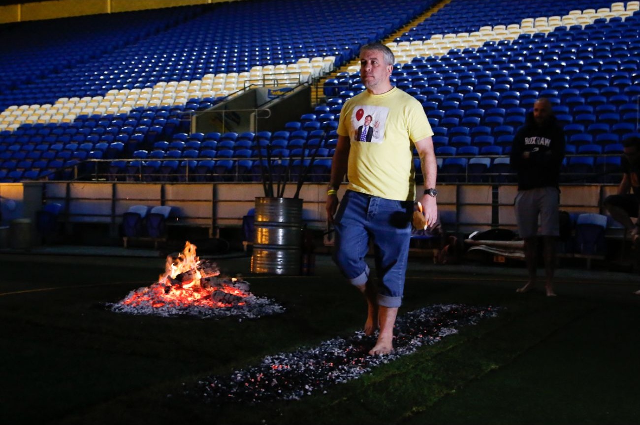 Participant walking over hot coals, Ty Hafan Firewalk 2025