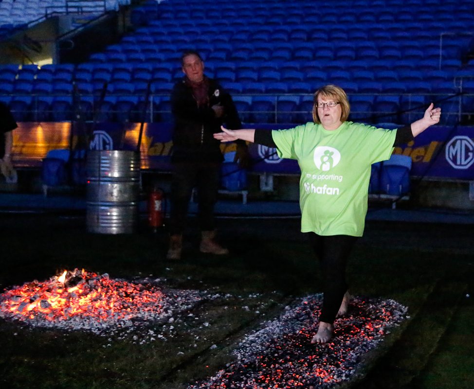 Pam Bowen walking across fire when talking part in the Firewalk event in 2024.