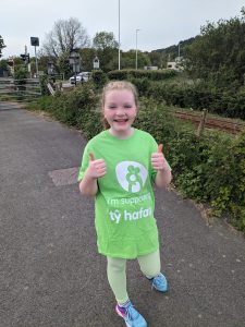 Maisie wearing herTŷ Hafan t-shirt while training.
