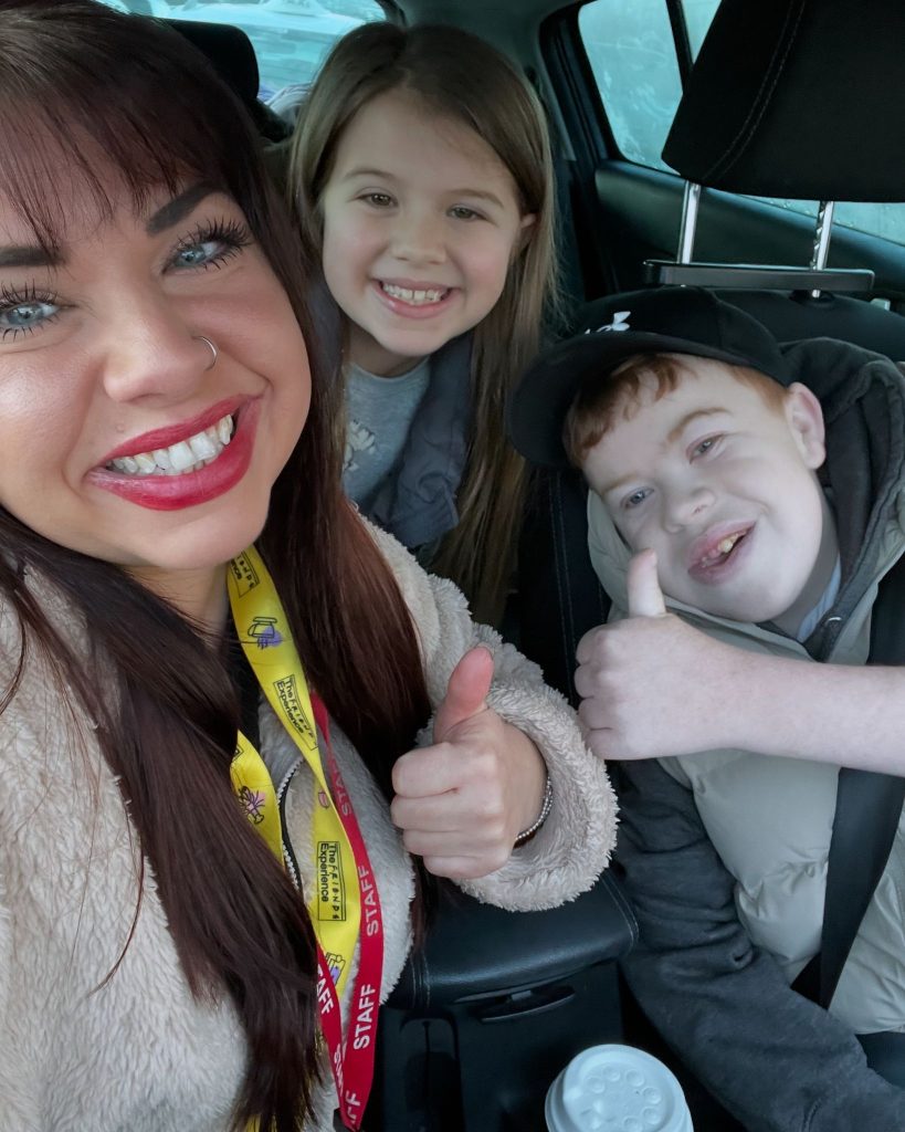 Kerry, Immie and David Spence smiling and doing a thumbs up