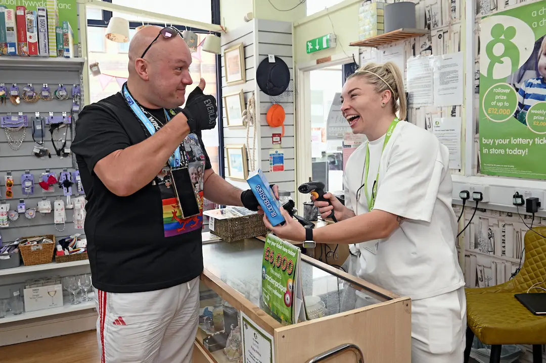 Lauren Price MBE shared a joke with a customer at the Caerphilly Tŷ Hafan shop