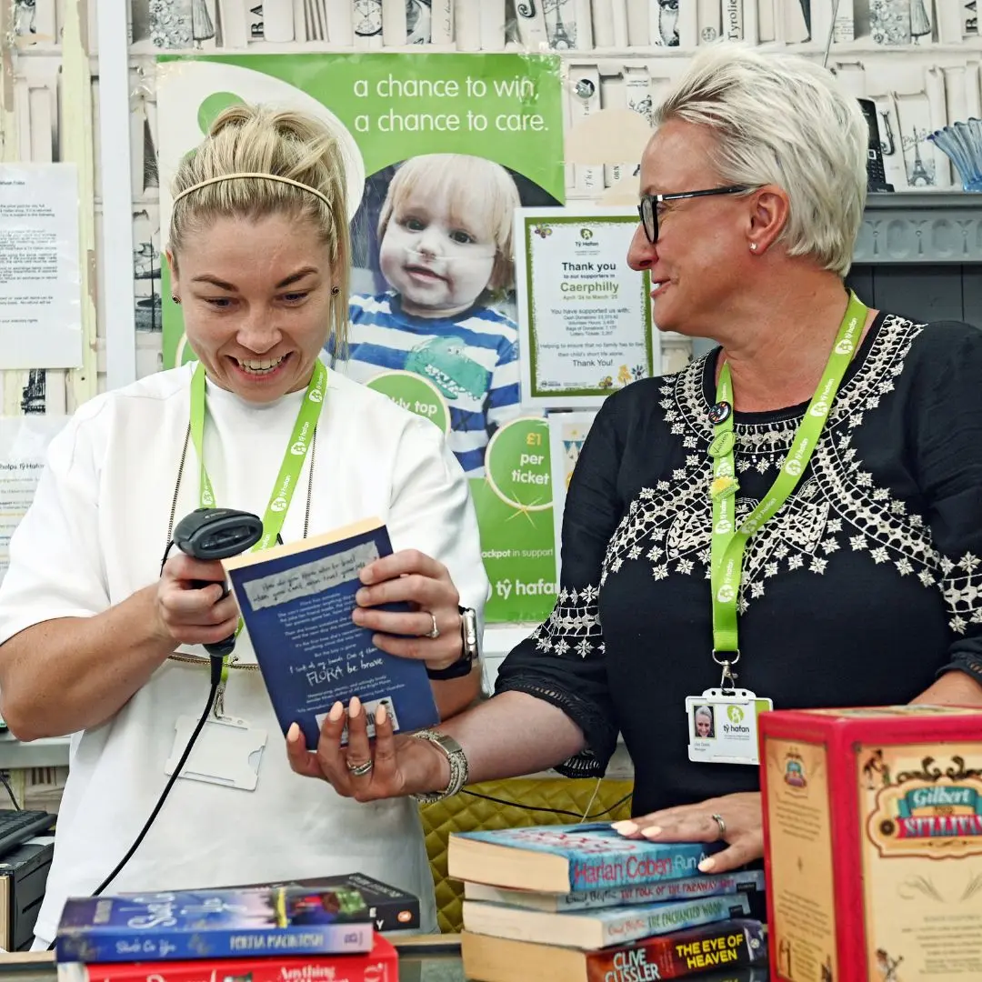 Lauren Price MBE scans items at the till in the Caerphilly Tŷ Hafan shop