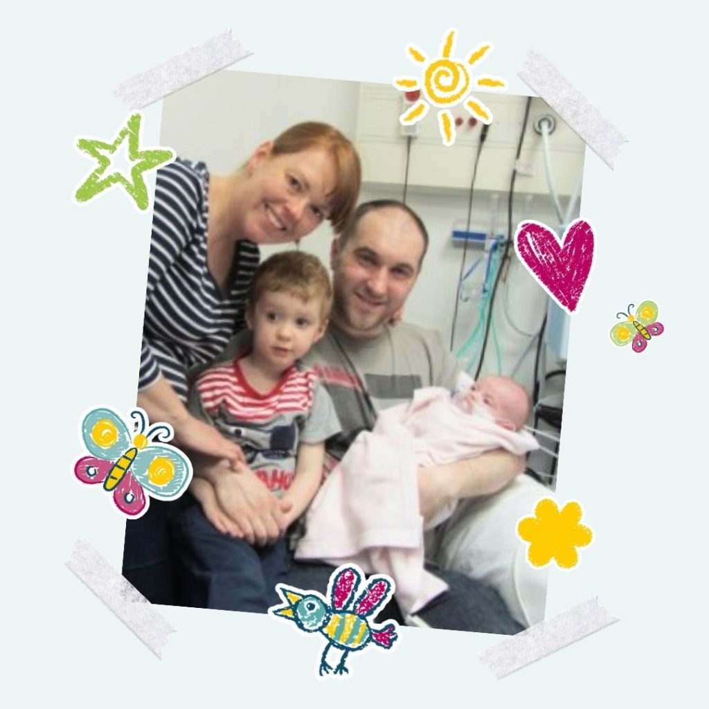 A photo of Angela, Rob, 3 year old Evan and baby Libby in hospital